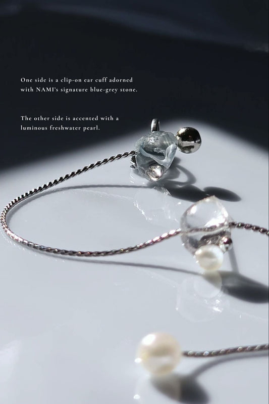 Adjustable NAMI multiway cuff and stud with chain and luminous pearls, featuring blended ocean-inspired silvery-blue and gray tones.