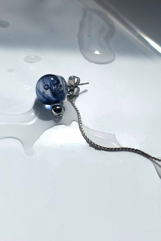 Close-up of SORA short drop’s blue orb and fine chain—blue is inspired by the shifting sky.