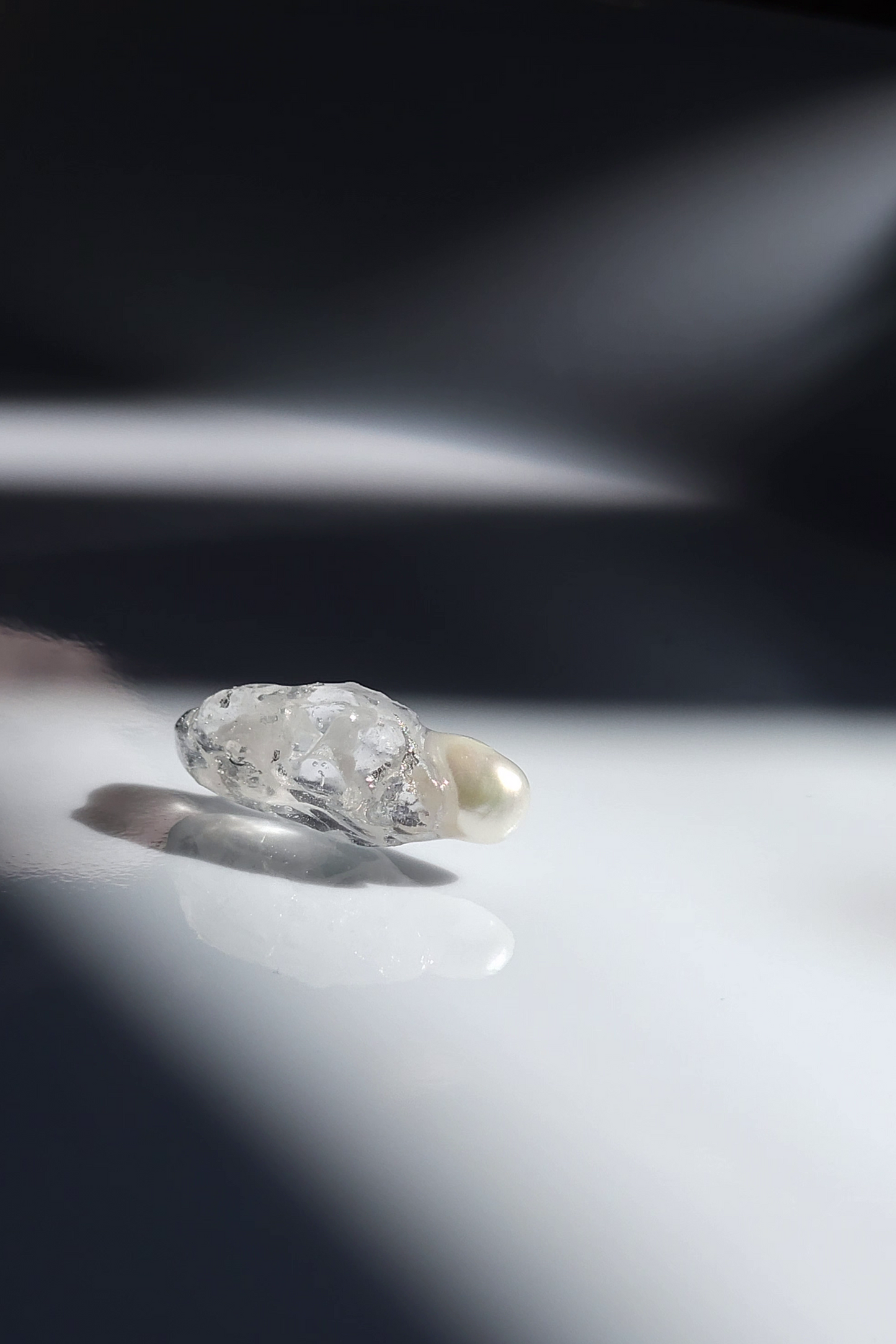 Close-up of KAKERA earring showing hand-molded clear stud only.