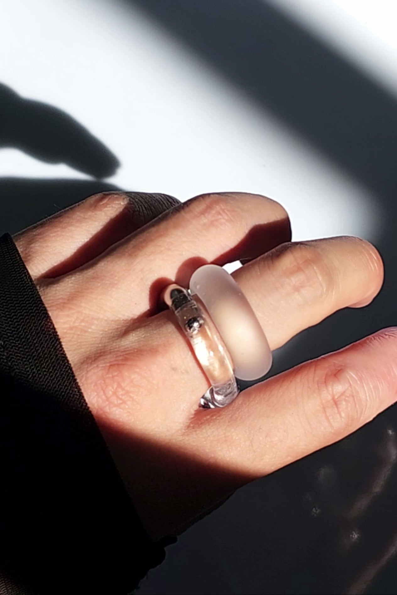 Model wearing TORORI silver as a ring, stacked with KIRI frosty matte ring, showcasing a sculptural look.