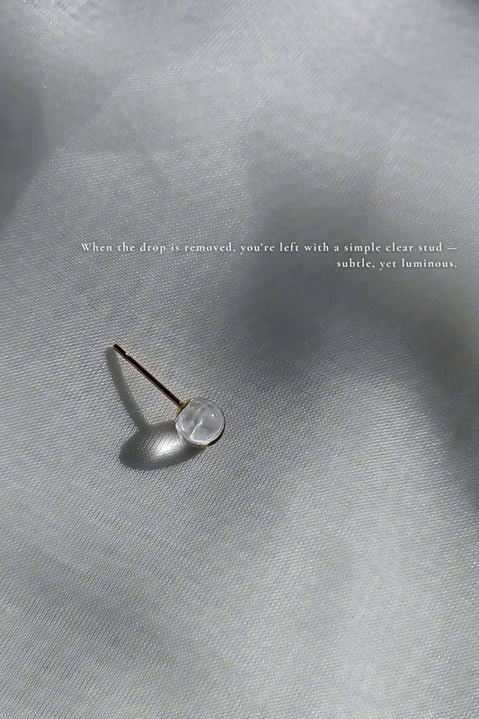 5mm clear stud from gold floral drop earring, MEIKA gold short drop, on a flat surface.