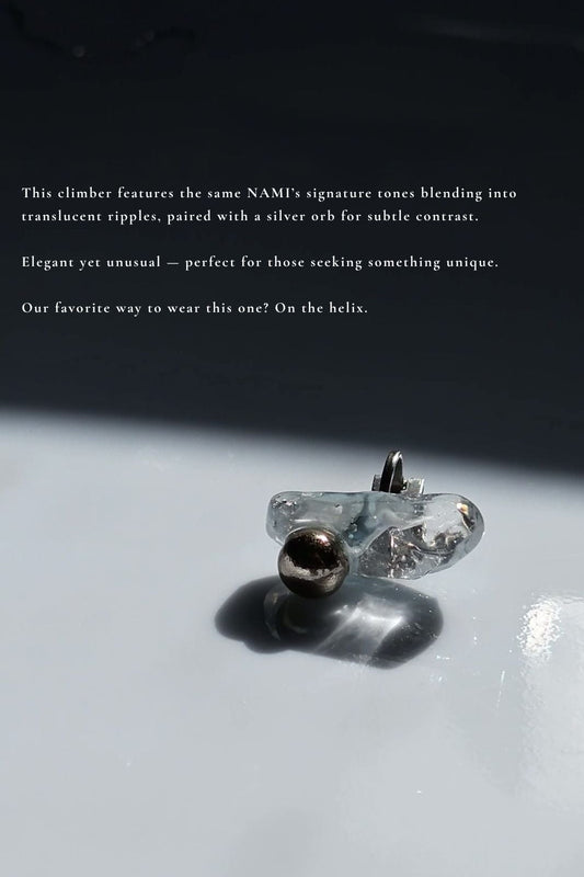 NAMI ear climber with hand-molded silvery blue-gray stone and silver orb, with a description.