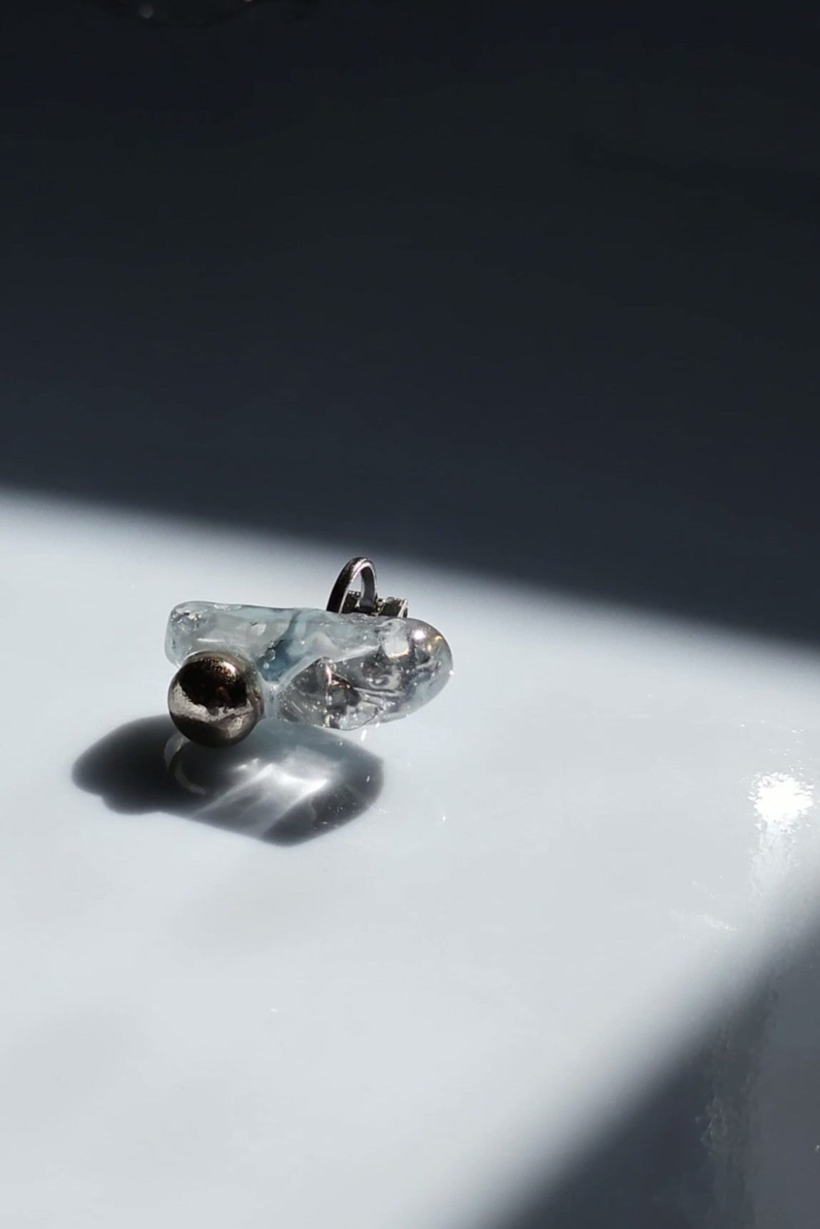 NAMI ear climber with hand-molded silvery blue-gray stone and silver orb, inspired by waves.