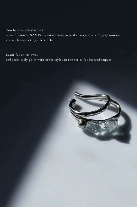 NAMI teardrop ear cuff with two silvery blue-gray hand-molded stones and tiny silver orb with detailed description.