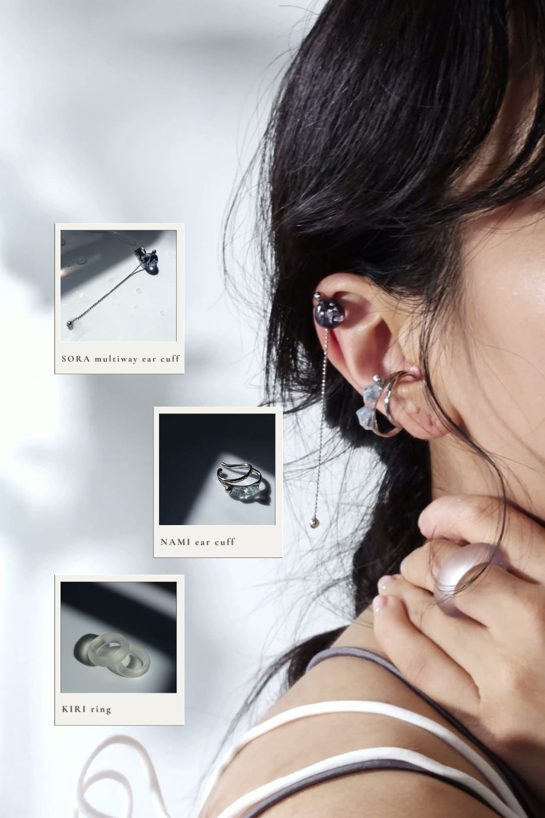 model wearing SORA multiway ear cuff, hand-blended blue orb ear cuff with chain, on helix and NAMI teardrop silver ear cuff, featuring hand-blended silvery blue stones, and KIRI frosty matte ring on the index finger.