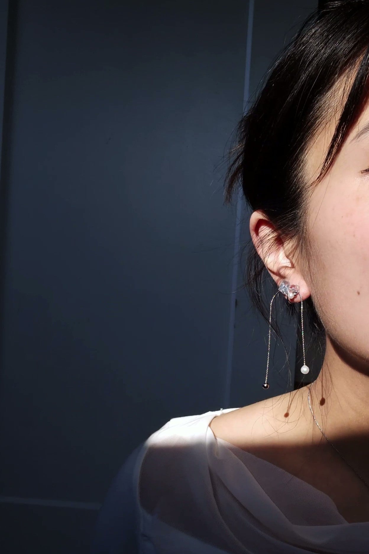 Model wearing NAMI mutliway cuff stud on earlobe, hanging freashwater pearl.