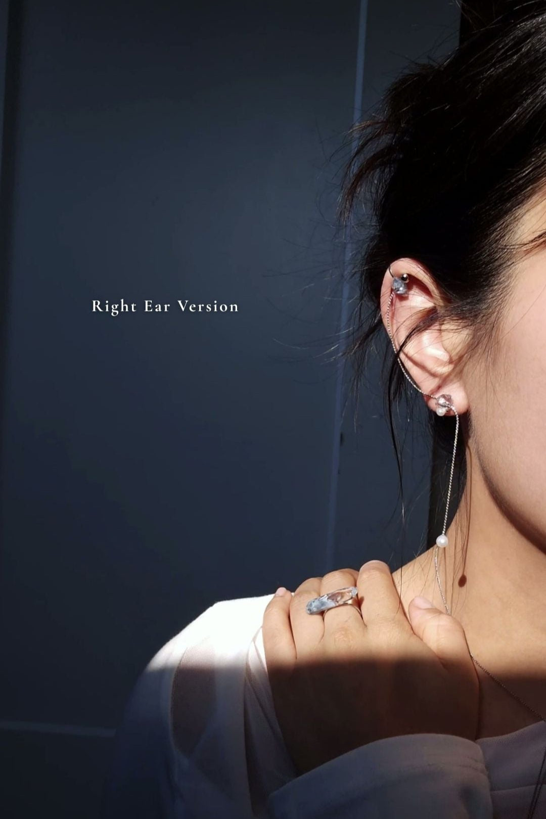 Model wearing NAMI multiway cuff & stud on earlobe with the chain hanging on a right ear.