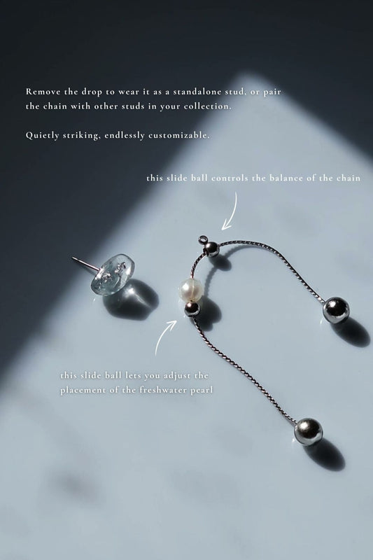 NAMI multiway drop earring with detachable chain and adjustable freshwater pearl, inspired by ocean waves, in hand-mixed silvery-blue tones.