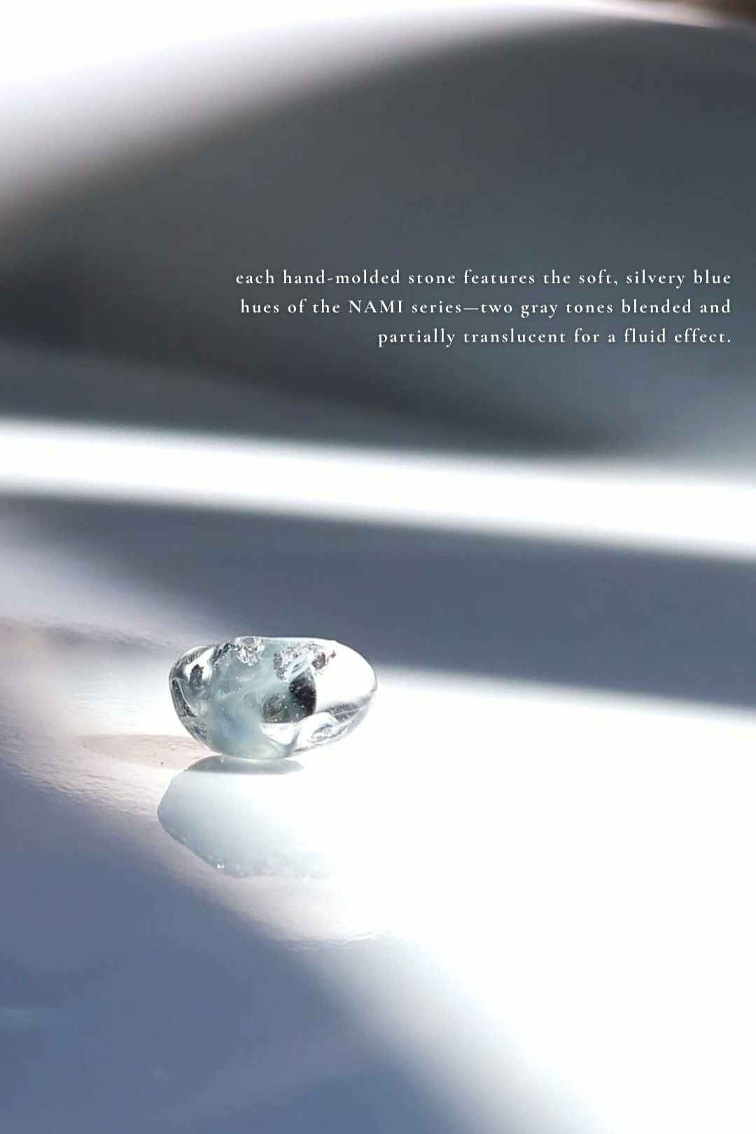 Close-up of the stud part from NAMI multiway drop earring with adjustable chain and pearl, silvery-blue wave-inspired design.