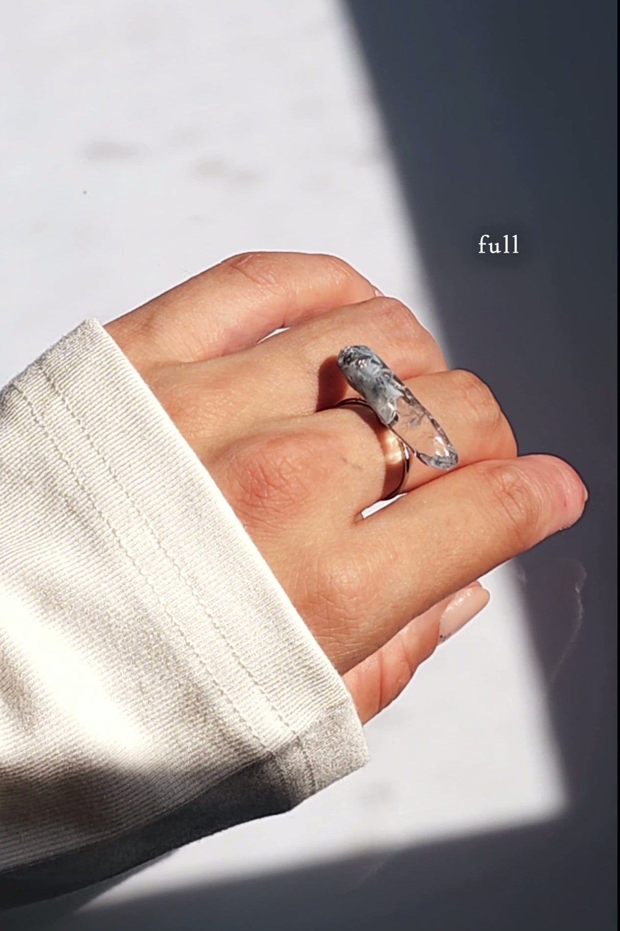 Model wearing NAMI ring in full size with hand-mixed silvery blue and gray translucent tones.