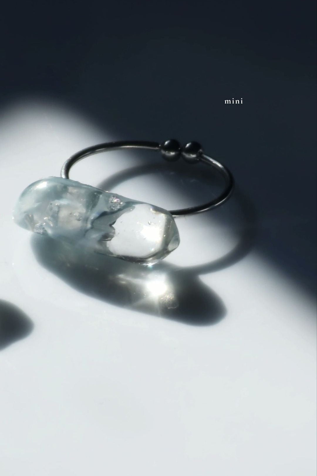 Handcrafted NAMI ring featuring blended gray and blue tones with fluid translucency, showing mini size for subtle styling.