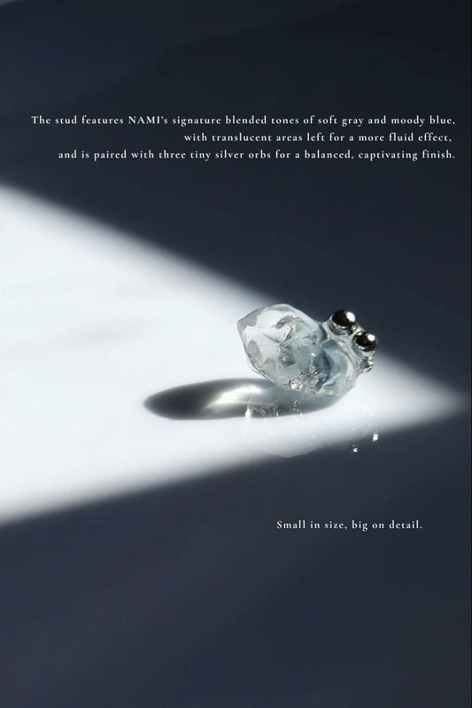 NAMI stud earring with silvery-blue hand-molded stone and three tiny silver orbs, inspired by ocean waves, shown alone for a minimal look.