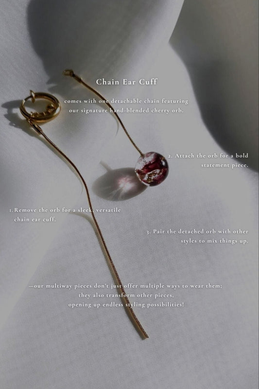 SAKURAMBO chain ear cuff in dark cherry red shown with description, flat lay on neutral background
