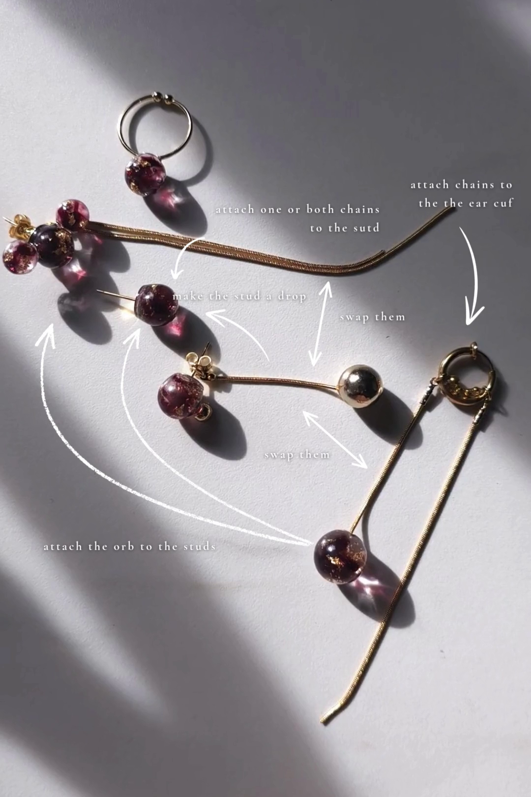 Full Sakurambo series in dark cherry red, flat lay showing earrings and ear cuffs for mix and match styling
