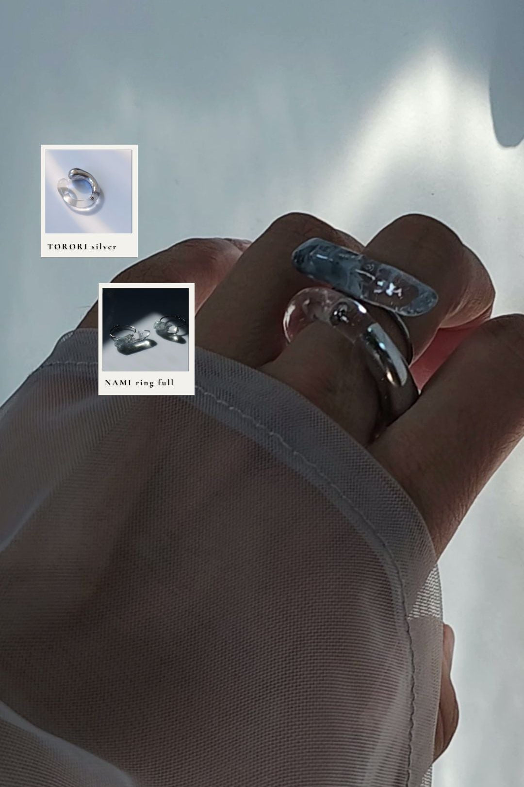 Close-up of a model wearing NAMI silvery blue ring stacked with TORORI silver sculptural ring on the middle finger.