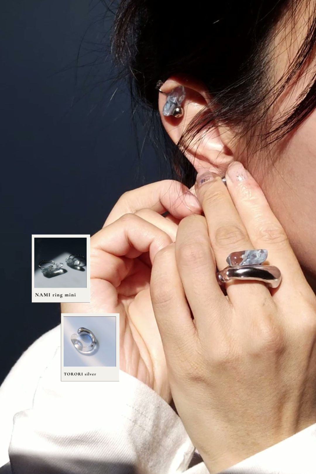 Close-up of a person wearing a TORORI silver ring stacked with NAMI blueish grey mini ring on the middle finger