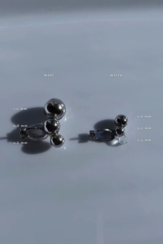 Flatlay of TSUBU mini silver and TSUBU micro silver comparing the desin and the size.