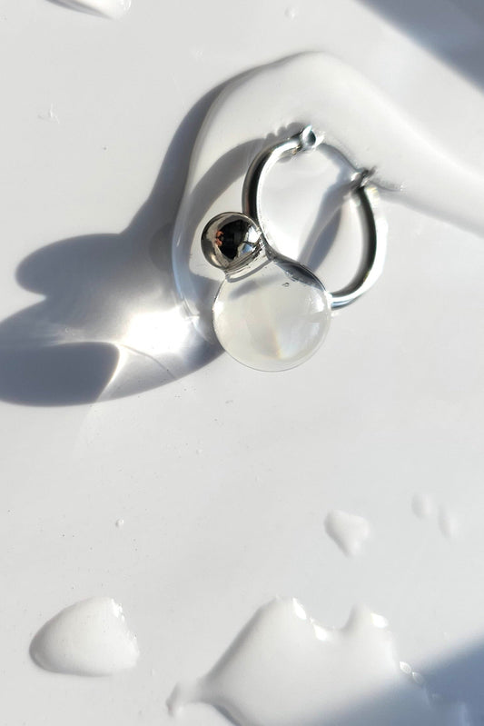YOTSUYU silver earrings with translucent and clear orb on silver hoop, inspired by night dew under moonlight, lightweight and luminous huggie.