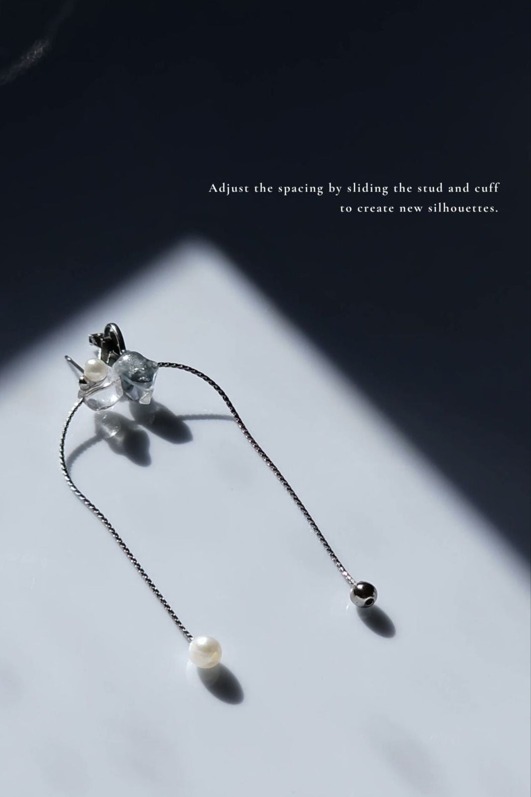 Handcrafted NAMI ear cuff and stud with chain and pearls, in fluid silvery-blue and gray tones, adjustable for different silhouettes.