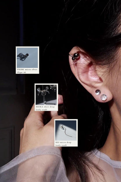 Close-up of model wearing TSUBU micro orb ear cuff on the helix with the stud from MEIKA short drop and the stud from REI silver micro drop