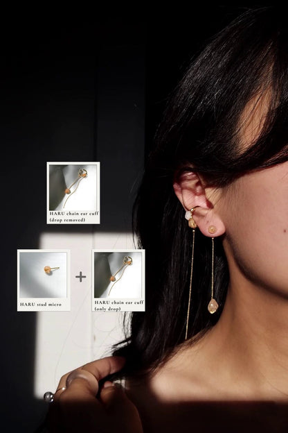 Model wearing a 6mm orb earring in orange beige, HARU micro stud, paired with a chain drop in orange beige, with gold chain ear cuff, HARU chain ear cuff