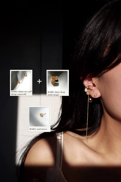 Model wearing an 6mm orb earring in orange beige, HARU micro stud,  with gold chain ear cuff, HARU chain earcuff.