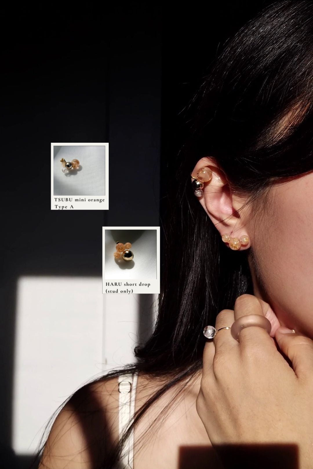 Close-up of a person wearing TSUBU mini orange orb earcuff on the helix with the stud from HARU orange series