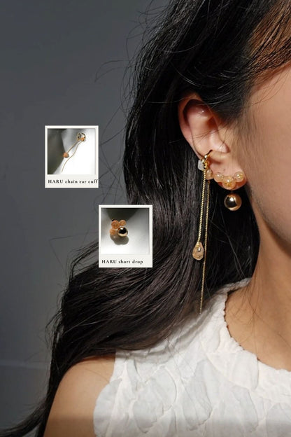 Model wearing orange beige orb drop earring, HARU short drop, paired with gold chain ear cuff with orange drop, HARU chain ear cuff.
