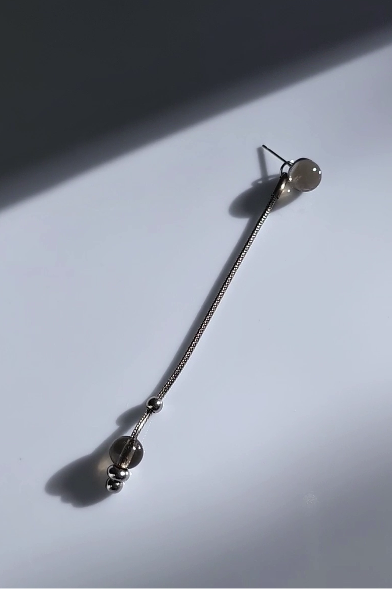silve long drop with translucent black orb, KAGE long drop on flat surface