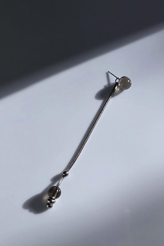 silve long drop with translucent black orb, KAGE long drop on flat surface