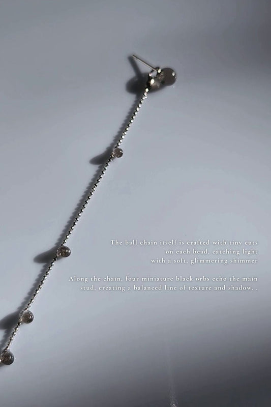 close-up of translucent black orb chain drop, KAGE silver chain drop.