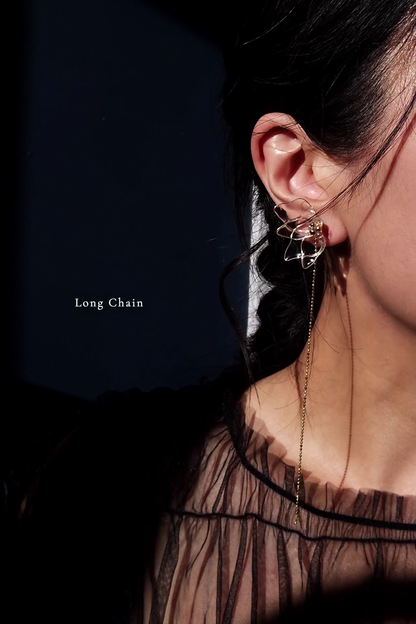 Model wearing clear floral earring in gold, MEIKA gold chain drop, with a long chain.