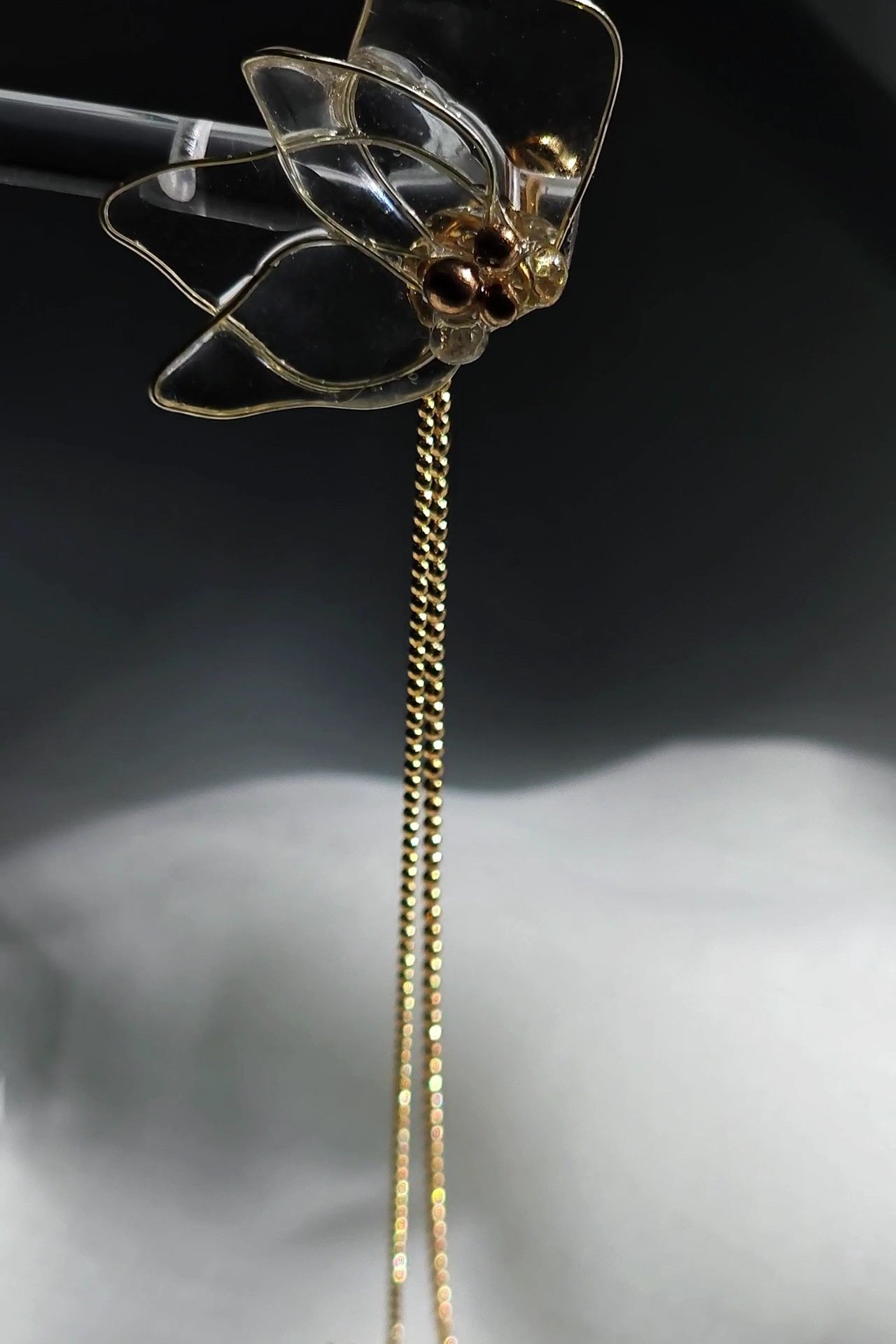 Clear floral drop earring with gold chains, MEIKA gold chain drop, showing the front side.