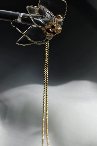 Clear floral drop earring with gold chains, MEIKA gold chain drop, showing the front side.