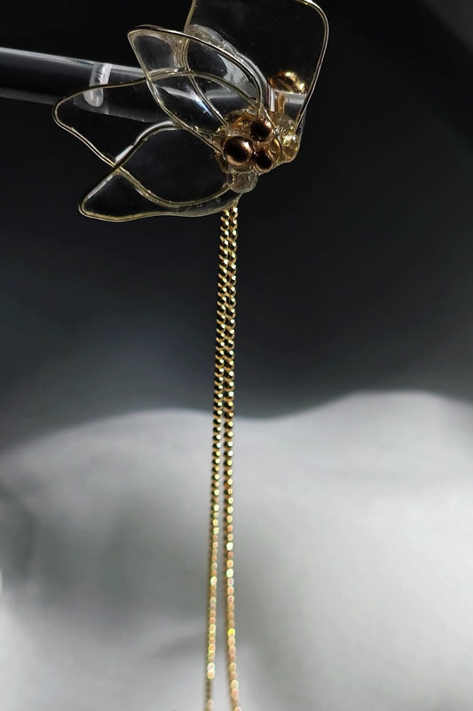 Clear floral drop earring with gold chains, MEIKA gold chain drop, showing the front side.