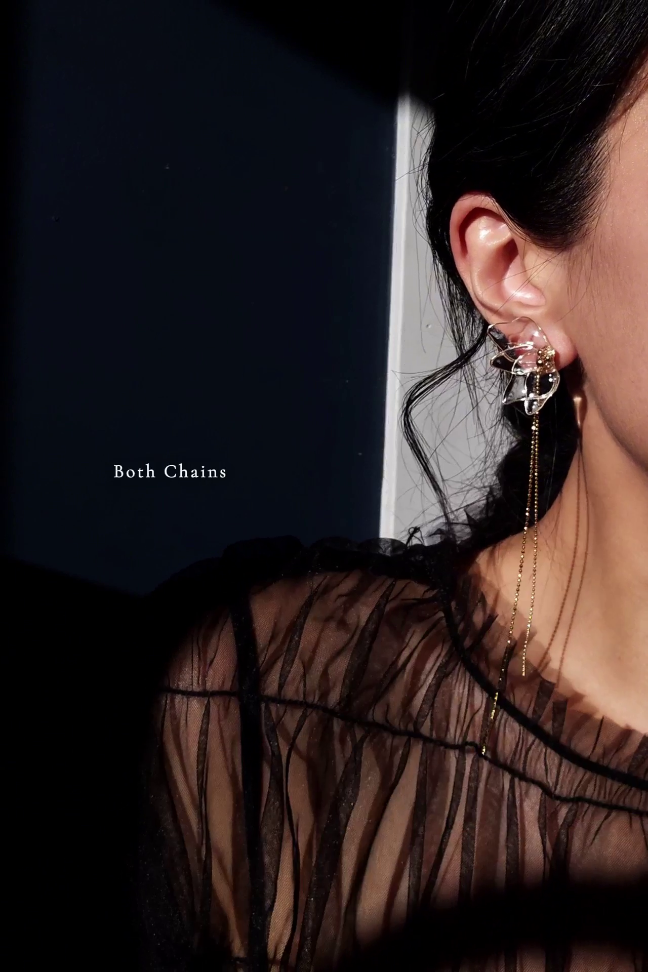 Model wearing gold clear floral earring, MEIKA gold chain drop.