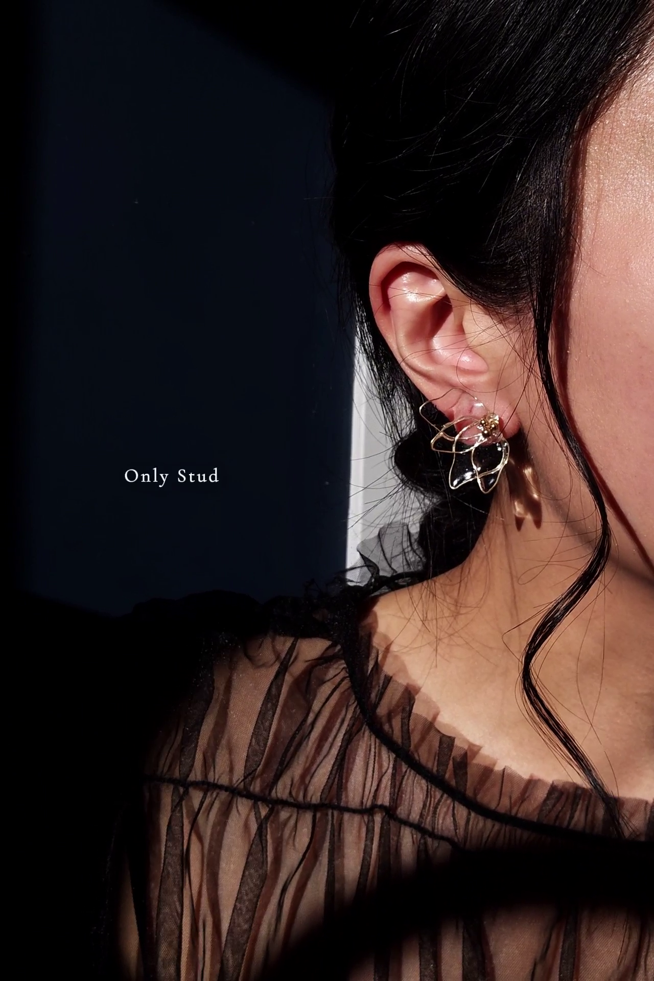 Model wearing a clear flower stud part from gold floral drop earring, MEIKA gold chain drop.