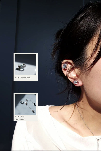 Model wearing NAMI ear climber on helix, paired with the stud part of NAMI multiway drop.