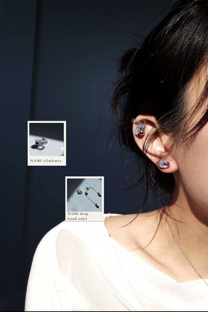 Model wearing NAMI ear climber on helix, paired with the stud part of NAMI multiway drop.