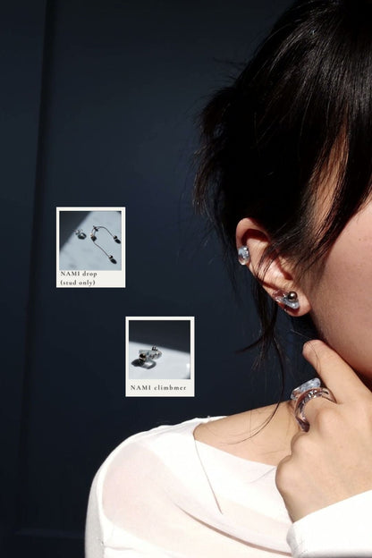 Model wearing NAMI ear climber on earlpbe, paired with the stud of NAMI multiway drop on helix. Model is wearing TORORI silver ring with NAMI ring mini.