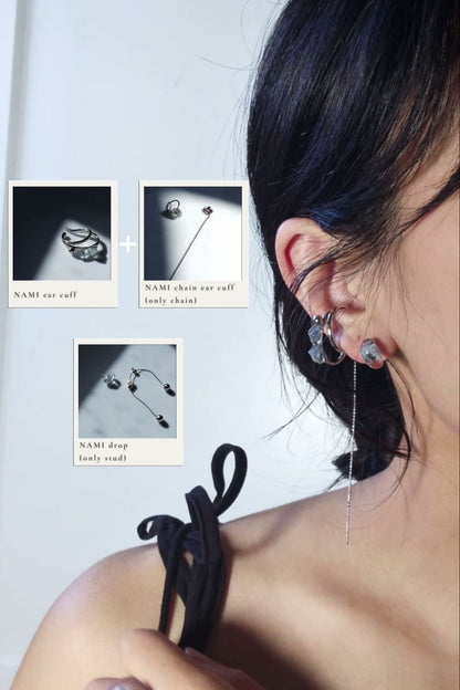 Model wearing NAMI teardrop silver ear cuff, featuring hand-blended silvery blue grey stones, with the chain from NAMI multiway chain ear cuff, and the stud from NAMI multiway drop on earlobe.