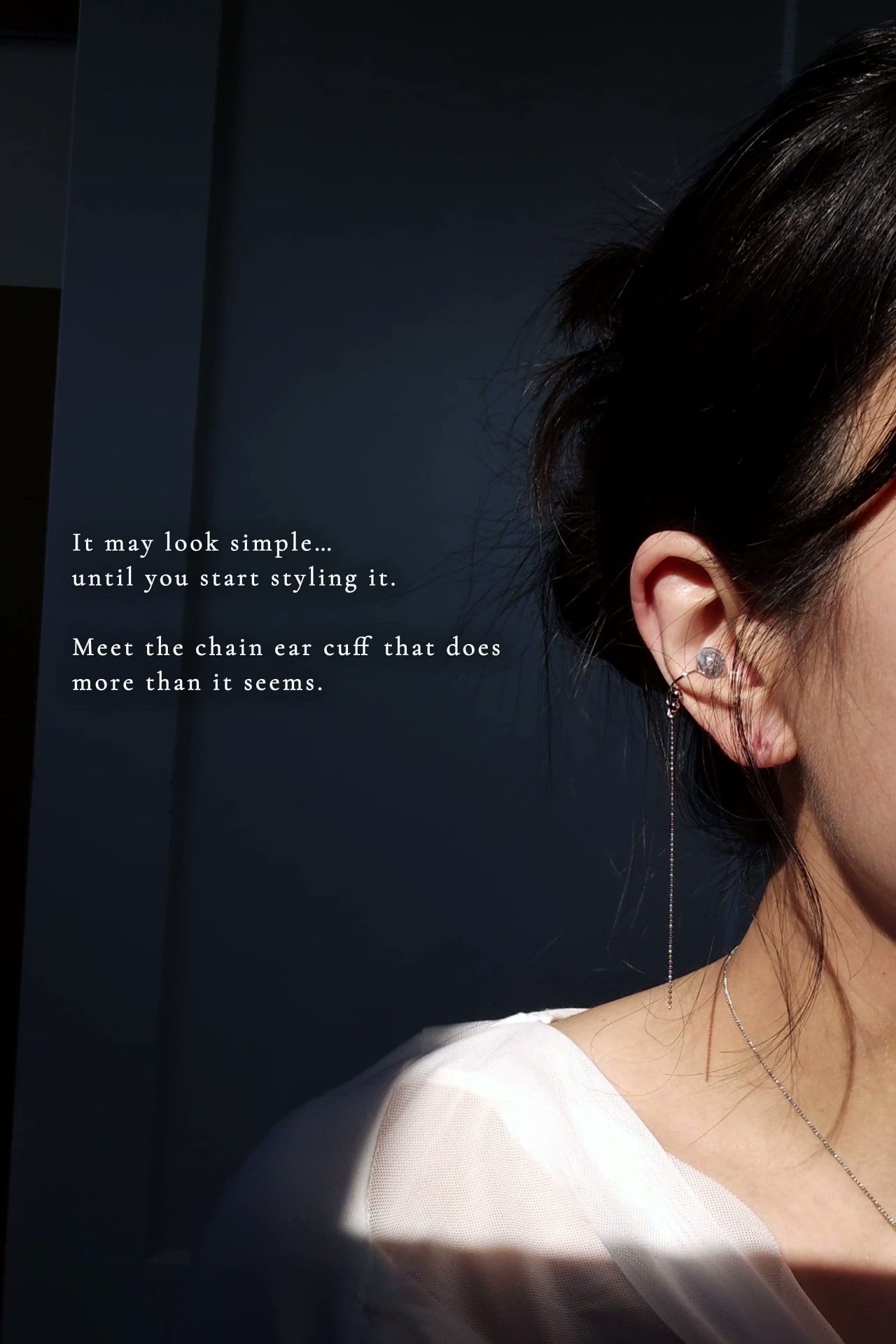 Model wearing NAMI multiway chain ear cuff on cartilage, featuring hand-blended silvery-blue stone and detachable chain.