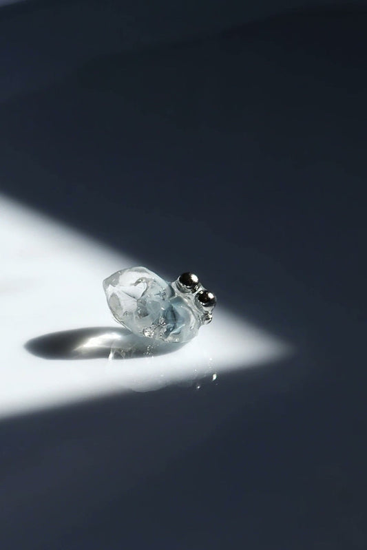 NAMI stud earring with silvery-blue hand-molded stone and three tiny silver orbs, inspired by ocean waves, shown alone for a minimal look.