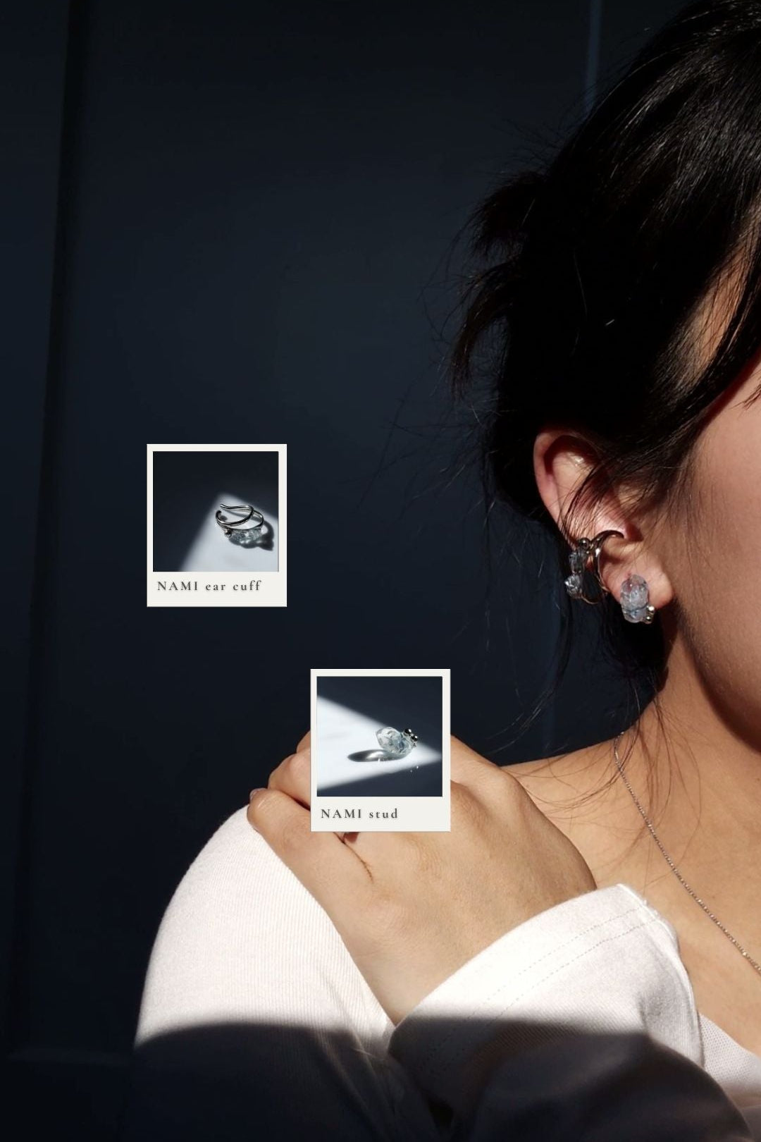 Person wearing NAMI teardrop silver ear cuff, featuring silvery blue grey stones with silver orb, paired with NAMI stud and KIRI frosty matte ring on the middle finger and NAMI mini ring on the ring finger.