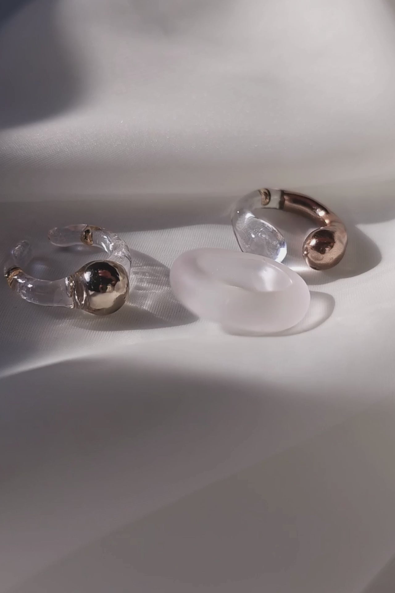 Model showcasing how to stack 3 rings in different variations - MITSUKi gold orb ring, TORORI gold sculptural ring and KIRI frosty ring.