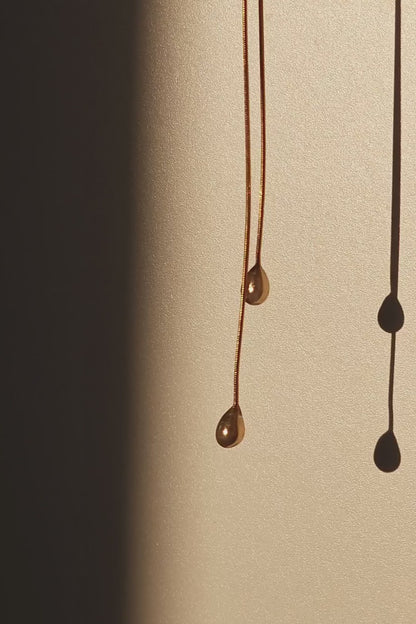REI gold / tie necklace - triangle