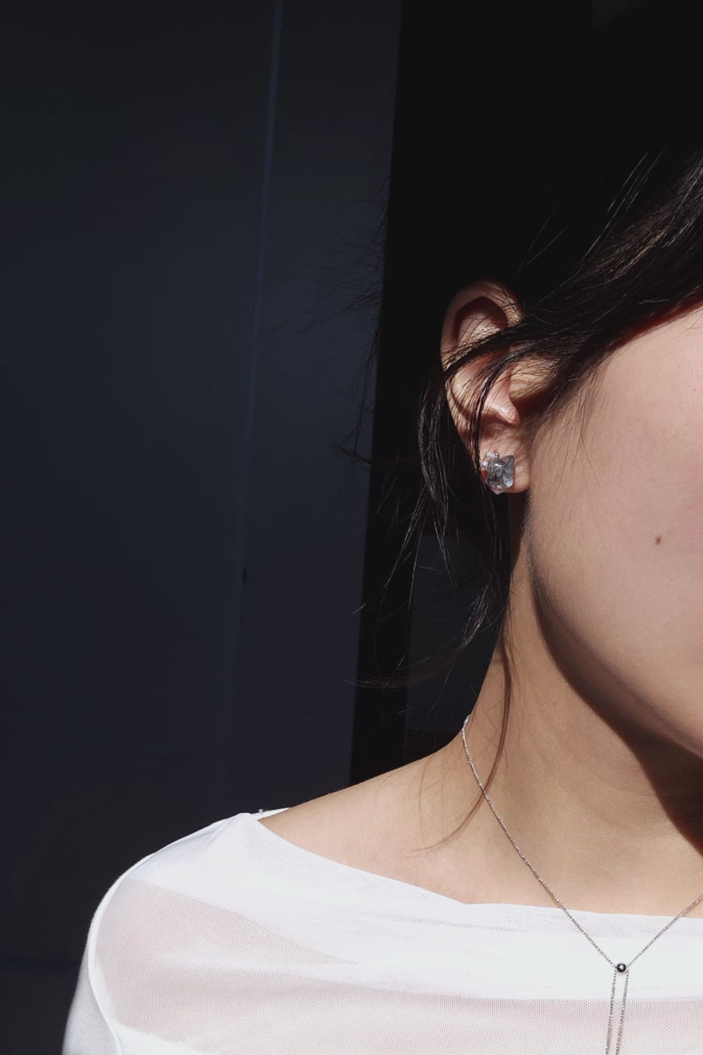 Video of explaining how NAMI multiway short drop stud earring with silvery-blue hand-molded stone, freshwater pearls, and detachable clear stone chain, transform.