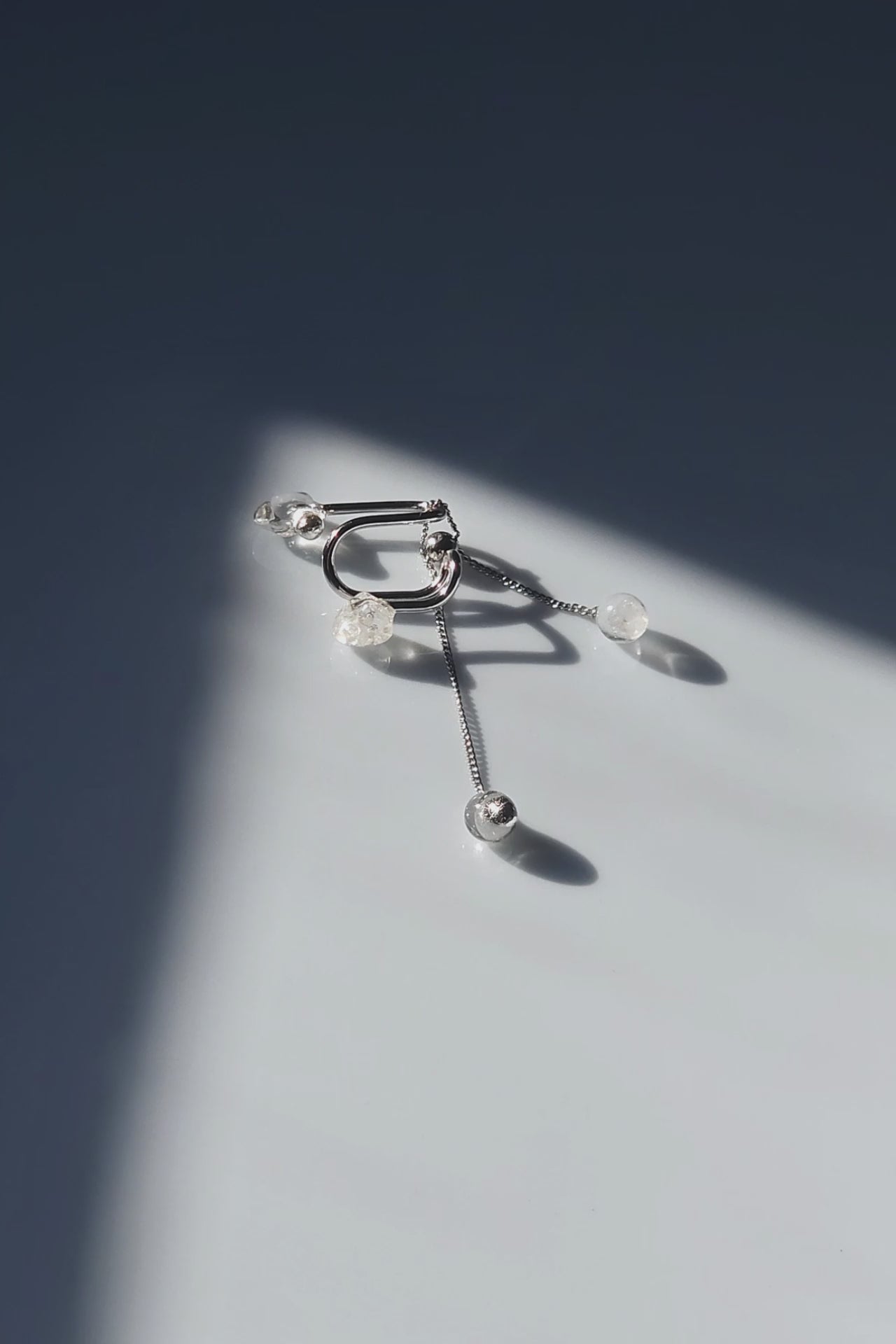 REI multiway ear cuff and ring set shown detached with adjustable chain, clear and melting ice stones, and slide ball for customizable styling.