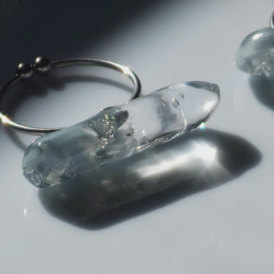 Close-up video of NAMI ring with hand-mixed silvery blue and gray translucent tones, inspired by ocean waves, shown in both mini and full sizes for stacking or solo wear.