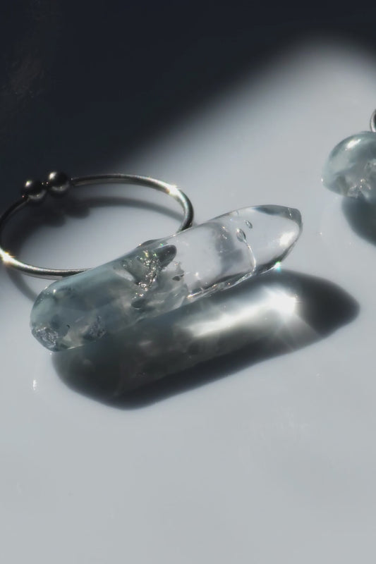 Close-up video of NAMI ring with hand-mixed silvery blue and gray translucent tones, inspired by ocean waves, shown in both mini and full sizes for stacking or solo wear.